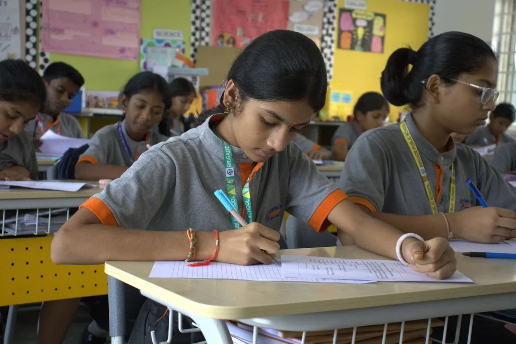 Student writing in class at Brigade Public School, Gurramguda campus